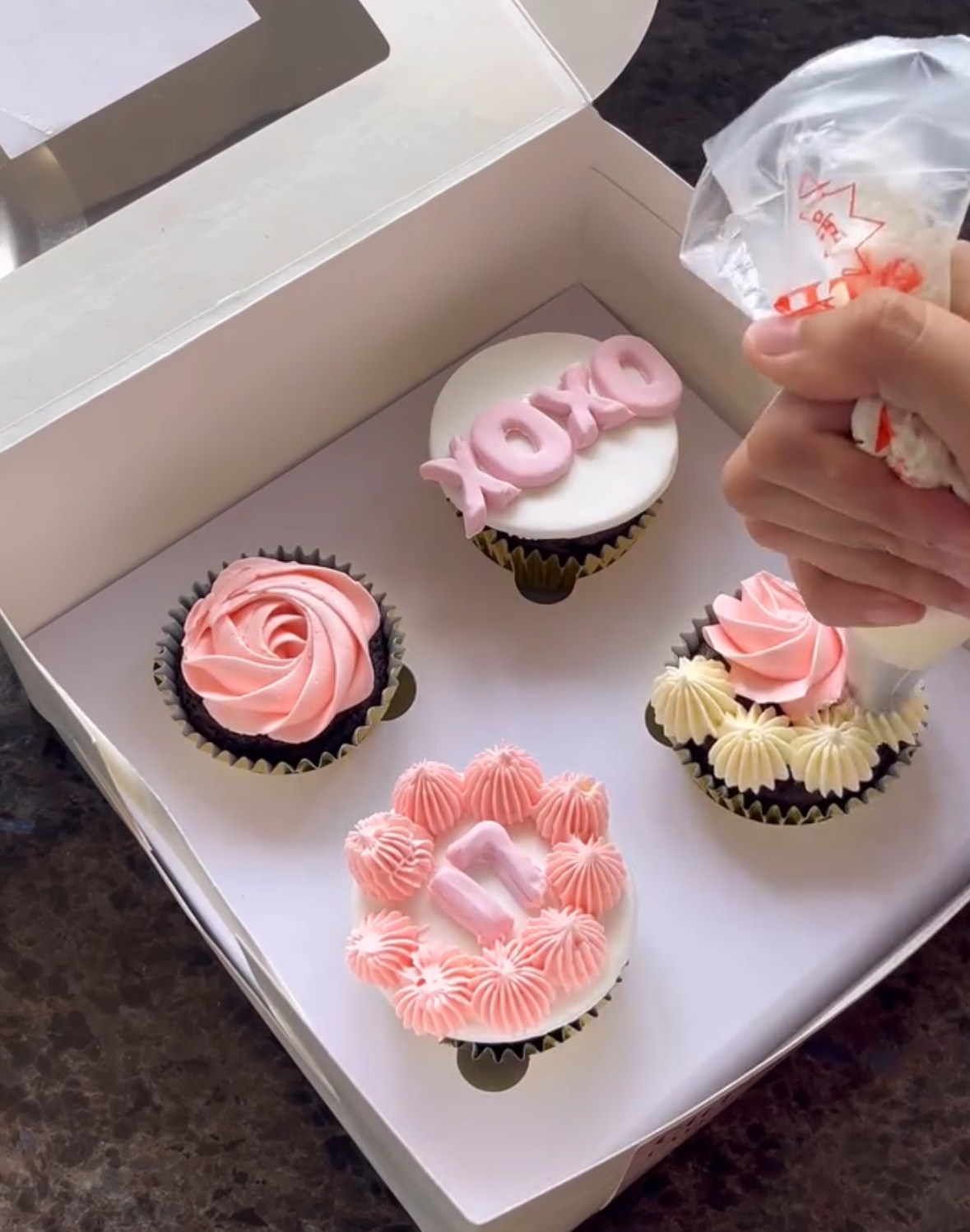 Samaira decorating cupcakes in her baking space